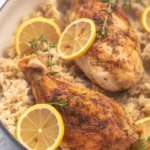 One-Pot Lemon Herb Chicken and Rice garnished with herbs and lemon slices.