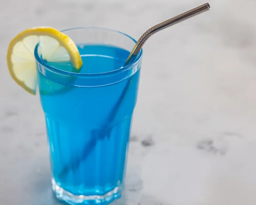 A refreshing Blue Tonic weight loss drink served in a glass with citrus garnishes.