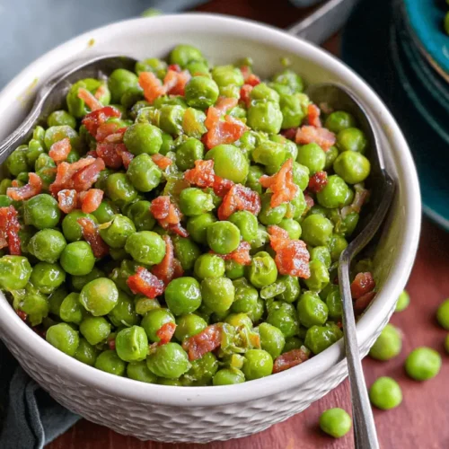 Close-up of a bowl of vibrant green peas with crispy pancetta bits, served on a rustic wooden table, highlighting the delicious Peas with Pancetta.