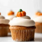 Gourmet pumpkin cupcakes with festive pumpkin toppers and creamy frosting in a beautiful arrangement.