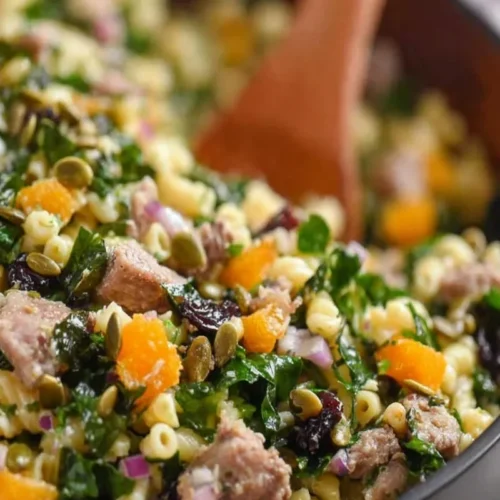 Harvest Pasta Salad with pasta, kale, turkey, cranberries, mandarin oranges, red onion, and pumpkin seeds.