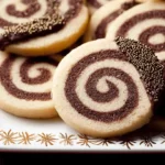 Close-up of chocolate-dipped Pinwheel Cookies with gold sprinkles on an elegant white and gold plate.