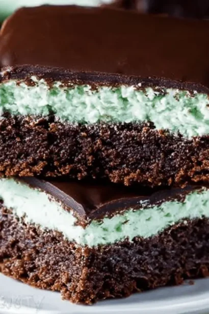 Close-up of perfectly layered Mint Chocolate Brownies with a rich chocolate base, vibrant mint filling, and glossy chocolate glaze.