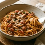 Skillet of hearty Dirty Spaghetti Recipe with seasoned ground beef, tomato sauce, and herbs