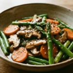 Spring Vegetable Stir-Fry: a colorful mix of bell peppers, broccoli, carrots, and snap peas sautéed in a hot wok.